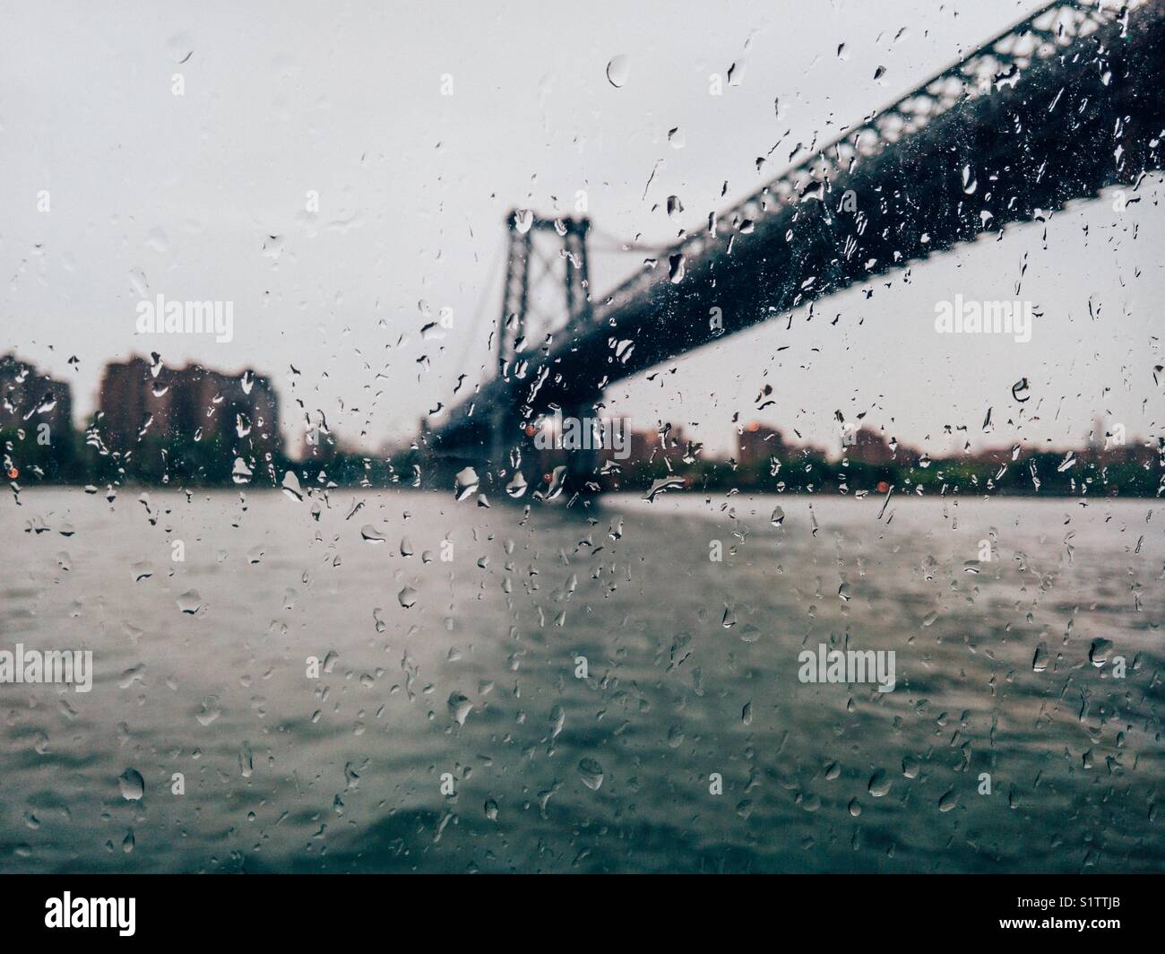 Williamsburg bridge seen through Rain drops on the window. Stock Photo