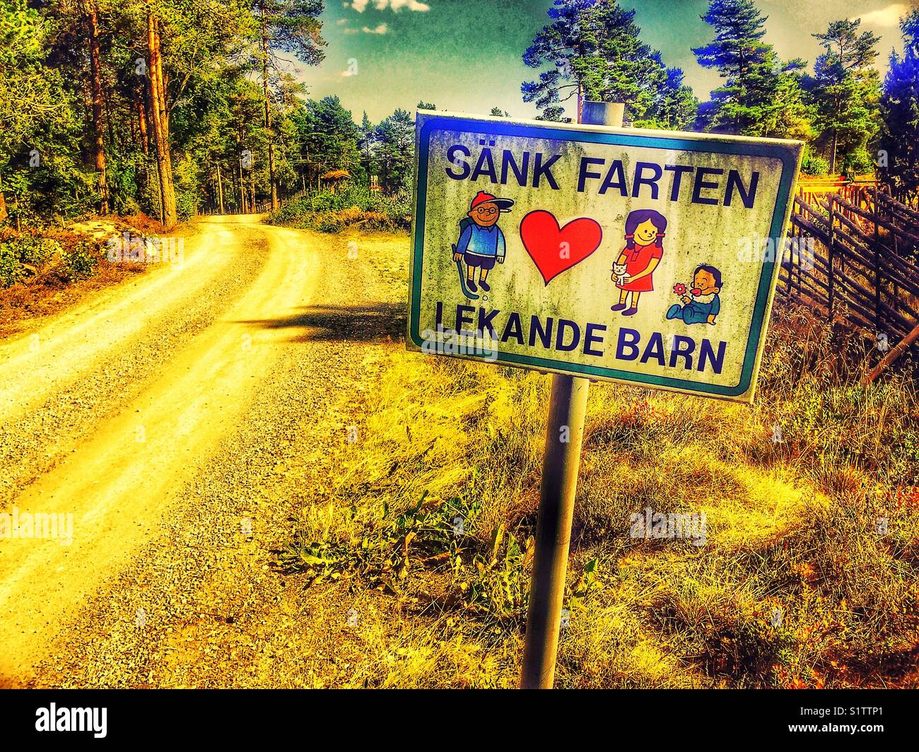 Slow down children playing sign next to track in rural Sweden, Scandinavia - Smartphone Captured Stock Image