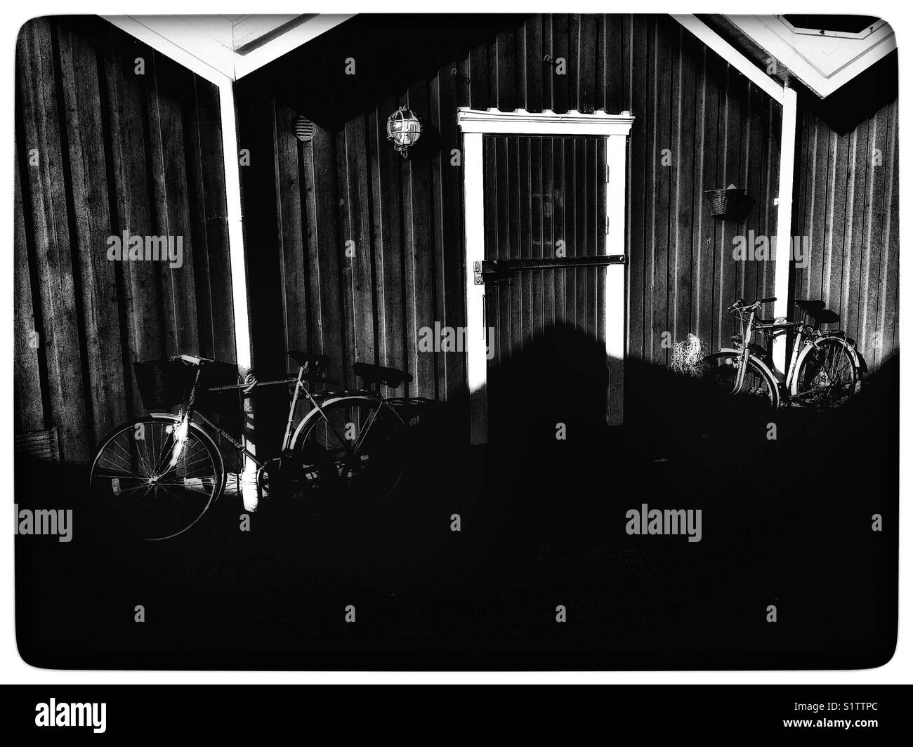 Timber cabin and bikes in shadow, Sweden, Scandinavia - Smartphone Captured Stock Image