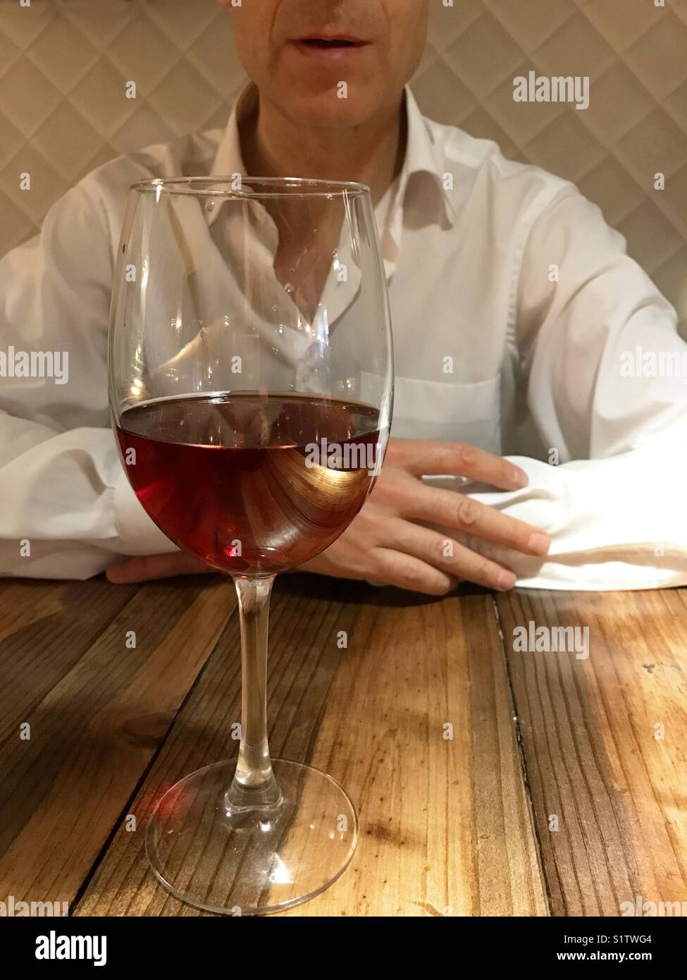 Man behind a glass of rose wine. - Smartphone Captured Stock Image