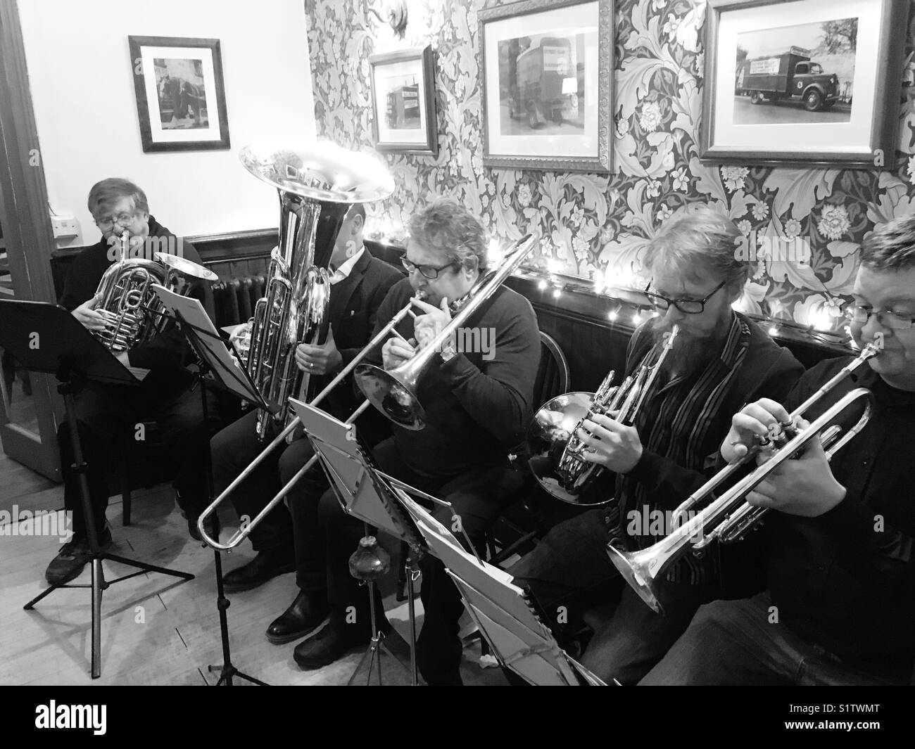 Brass quintet playing Christmas carols in a South London pub Stock Photo
