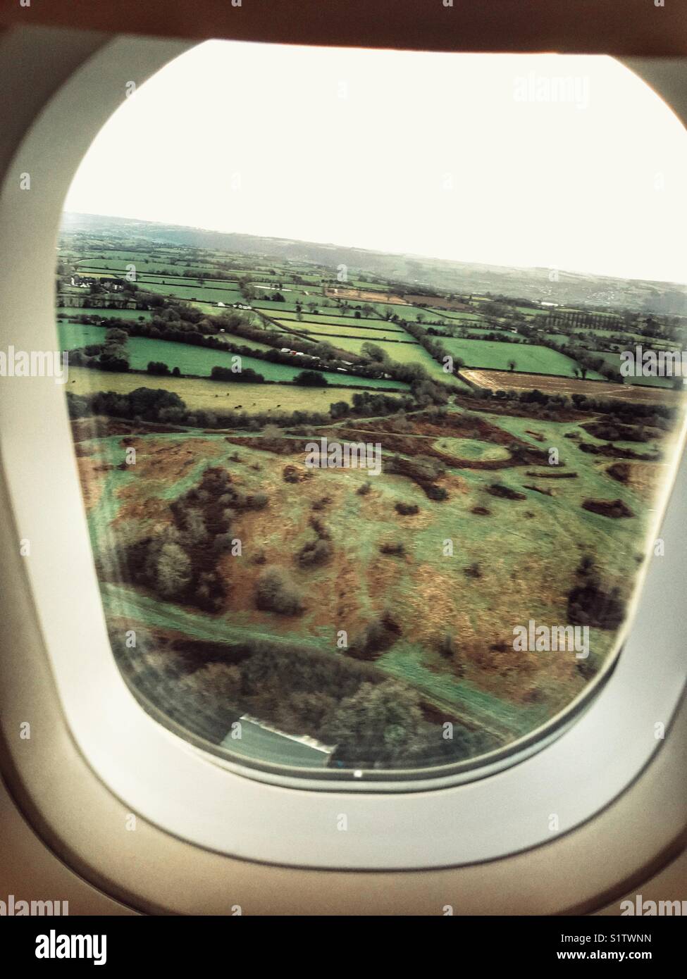 View from an aeroplane over green fields in winter, coming in to land at Bristol, UK. - Smartphone Captured Stock Image