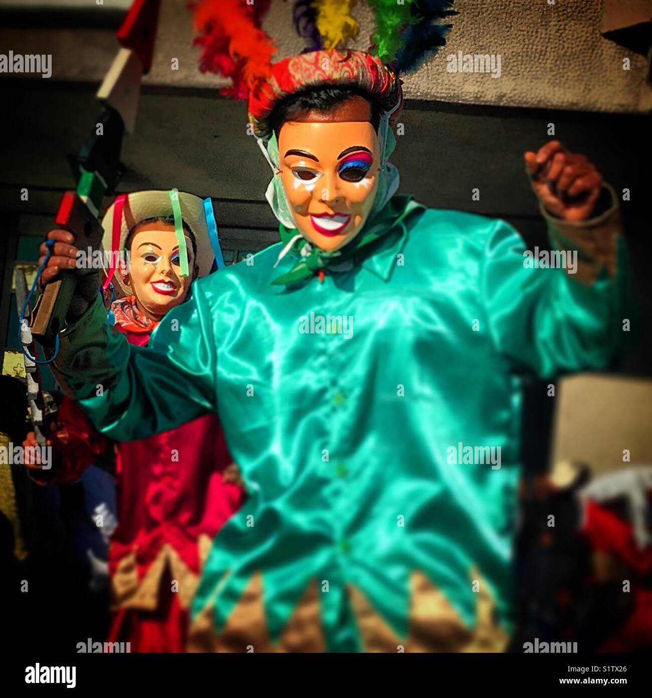 Danzantes wearing masks and holding rays perform during the annual pilgrimage to Our Lady of Guadalupe basilica in Mexico City, Mexico - Smartphone Captured Stock Image