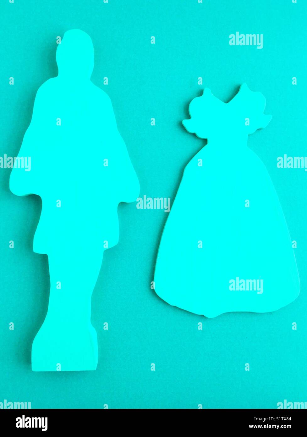 Monochromatic cutout shapes of a woman and a frilly dress. Stock Photo