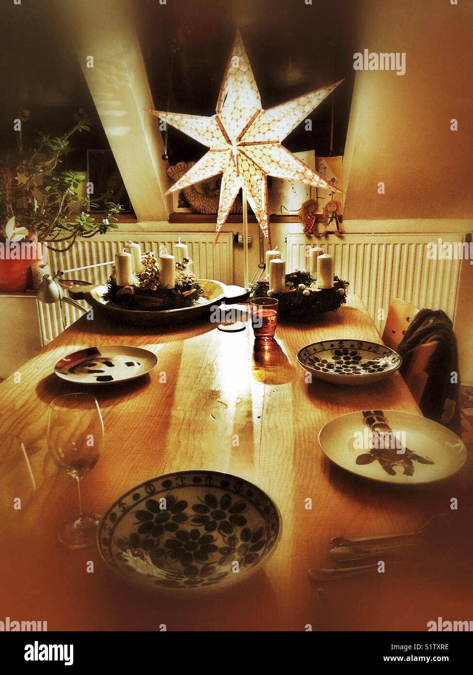 Illuminated star above table, christmas mood - Smartphone Captured Stock Image
