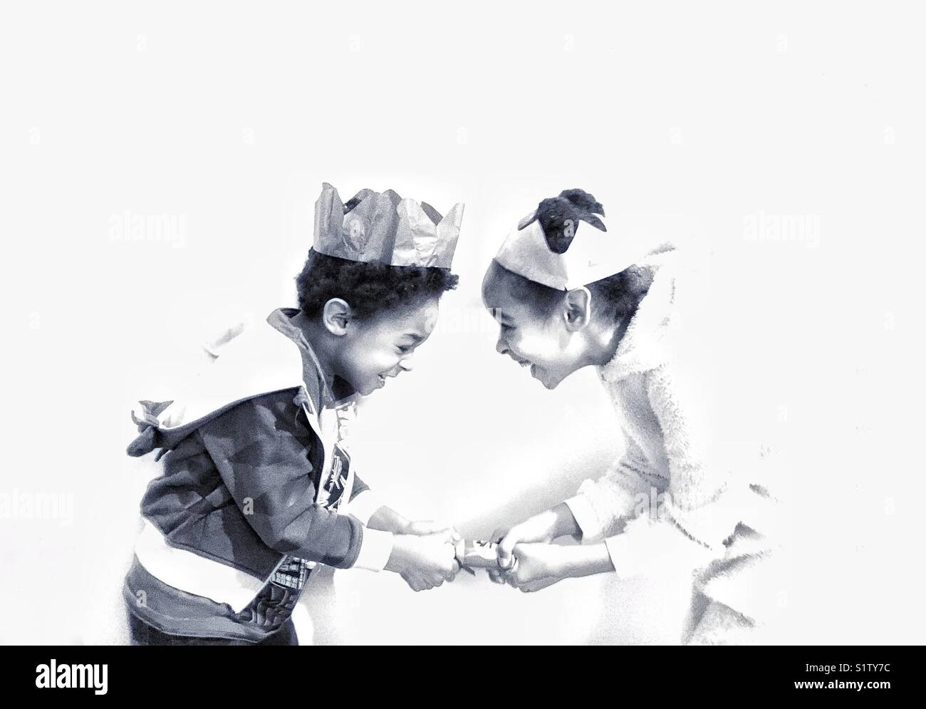 Children pulling a Christmas cracker - Smartphone Captured Stock Image