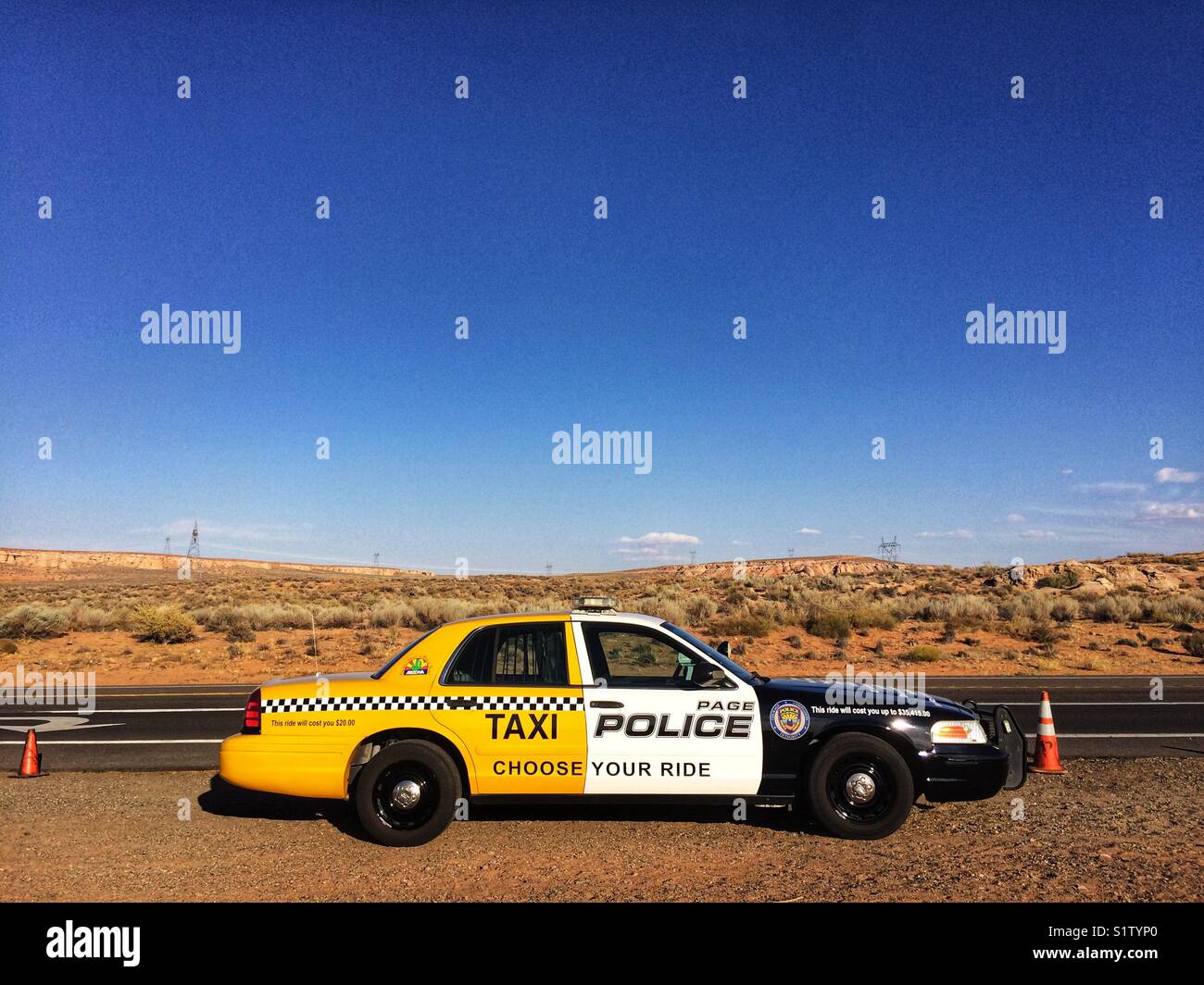 Taxi & Police car in Page, Arizona, USA. A police car painted partially as a taxi, part of a campaign against drunk driving - Smartphone Captured Stock Image
