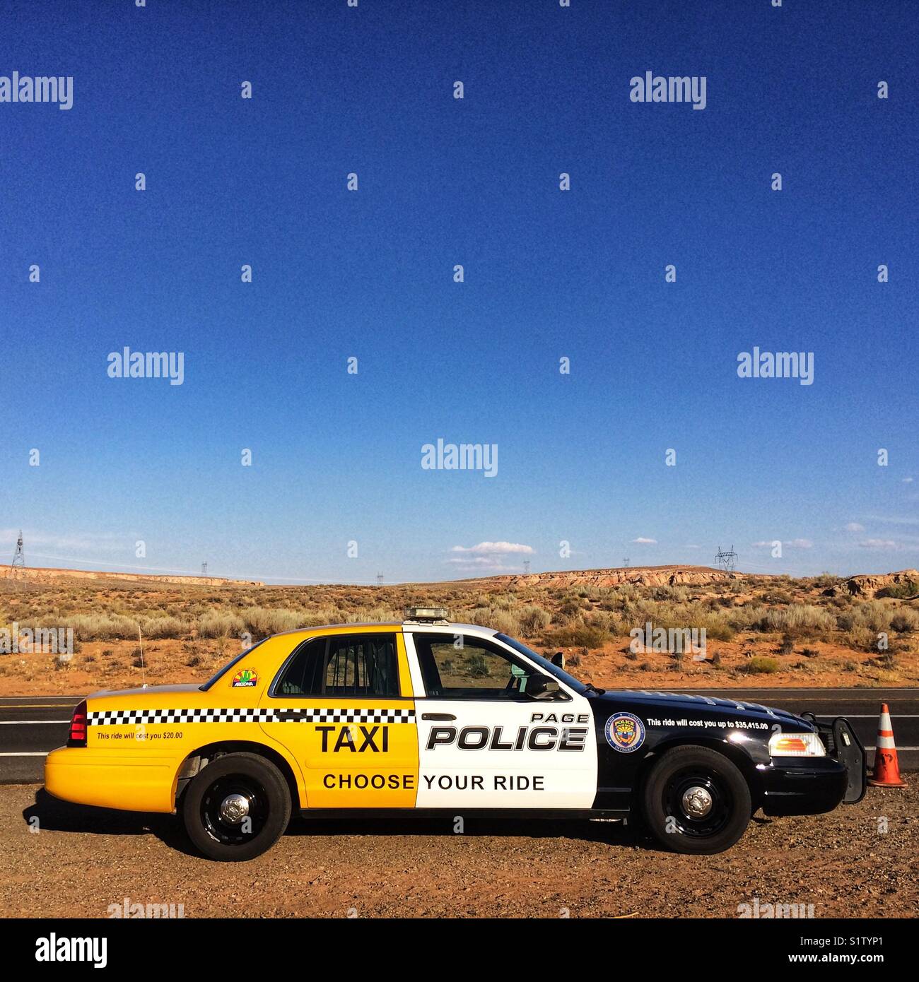 Taxi & Police car in Page, Arizona, USA A police car painted partially as a taxi, part of a campaign against drunk driving Stock Photo