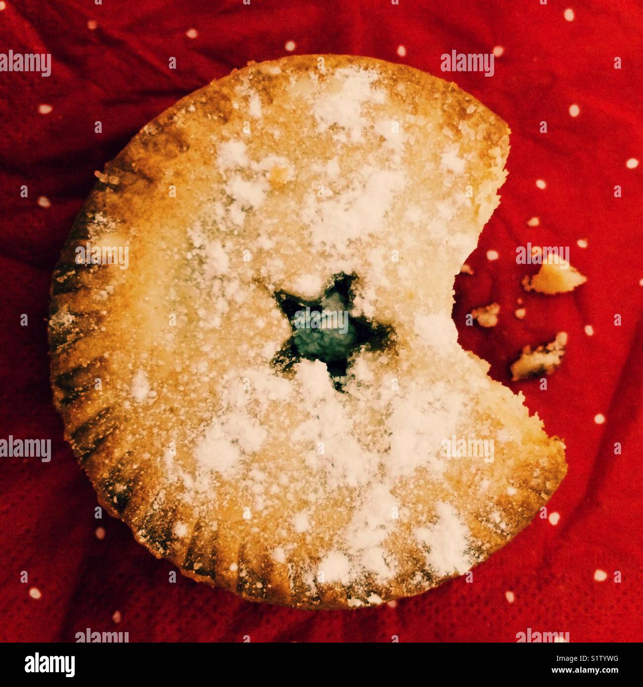 A Christmas mince pie with a bite taken out - Smartphone Captured Stock Image