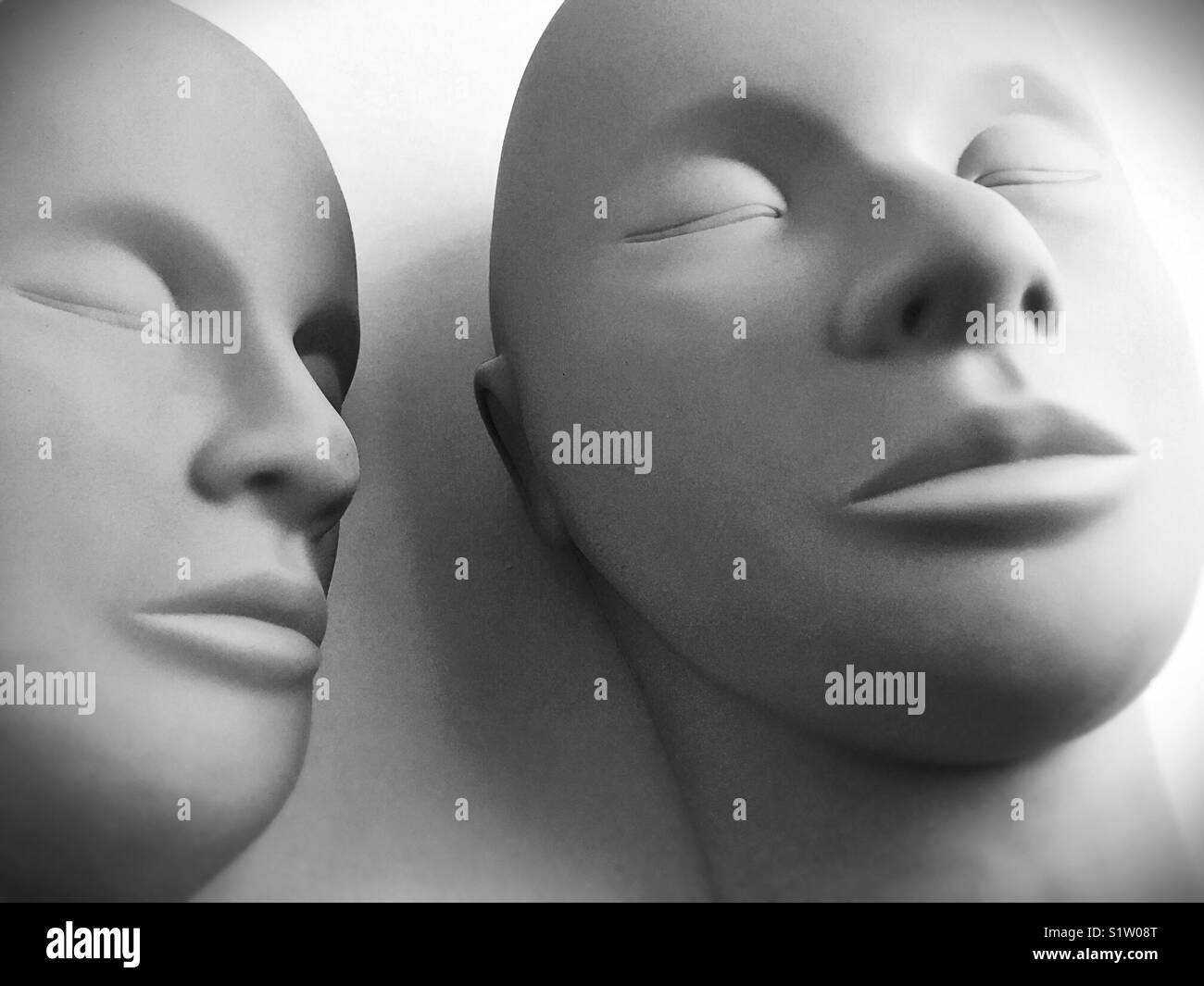 Two rubber human looking heads. Stock Photo