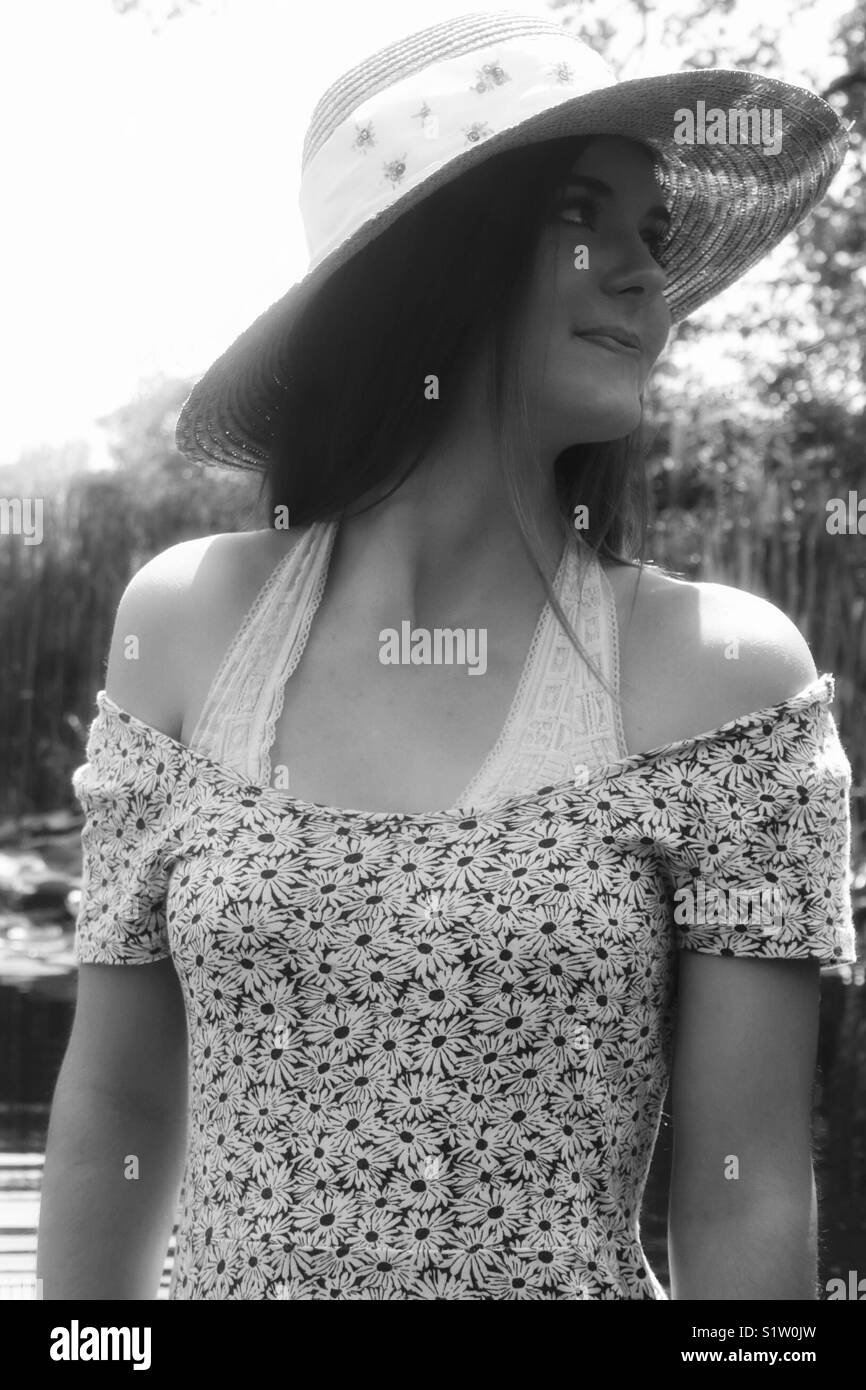 Young woman in sun dress and hat Stock Photo Alamy