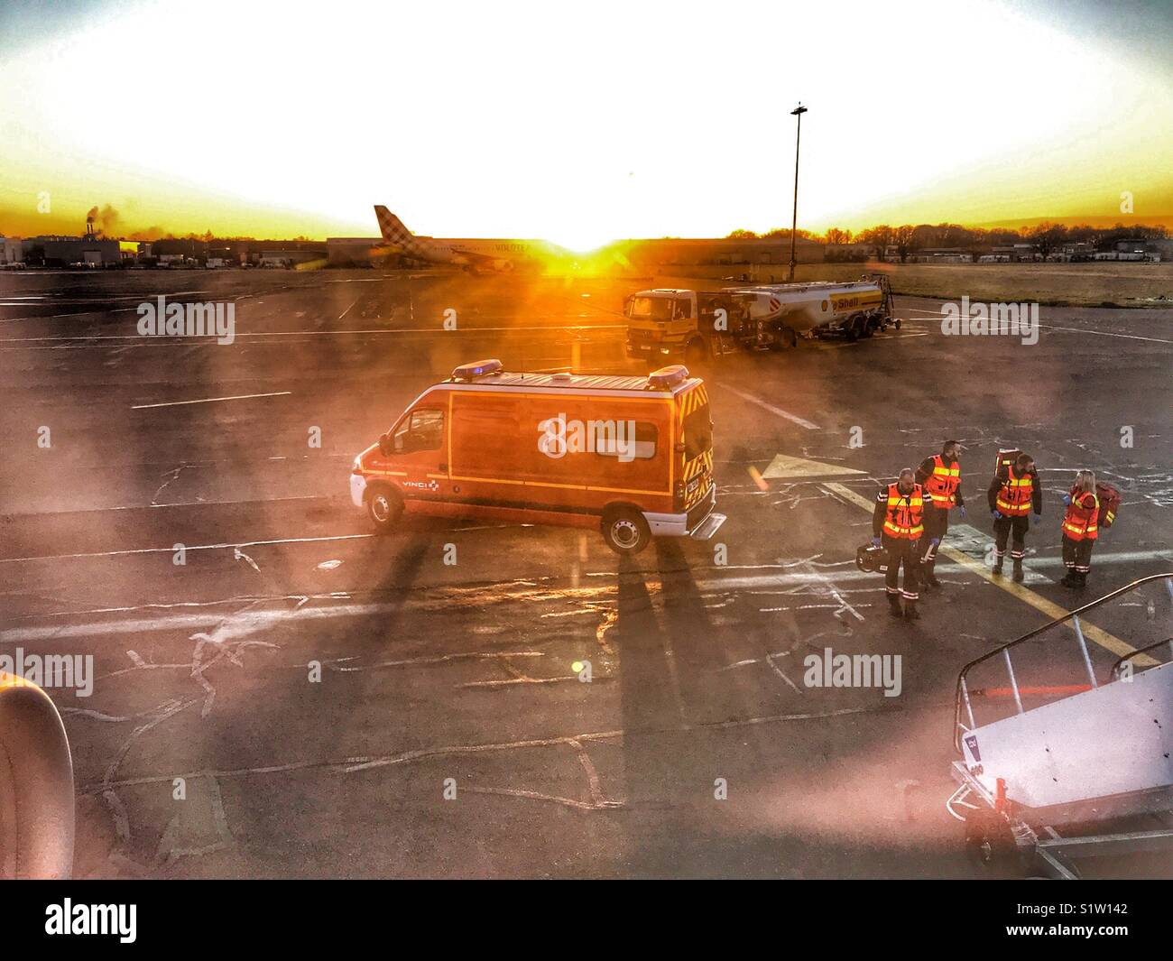 Emergency services waiting on the ground to meet an aeroplane which has landed in Nantes, France because of a passenger with a medical emergency on board the flight. - Smartphone Captured Stock Image