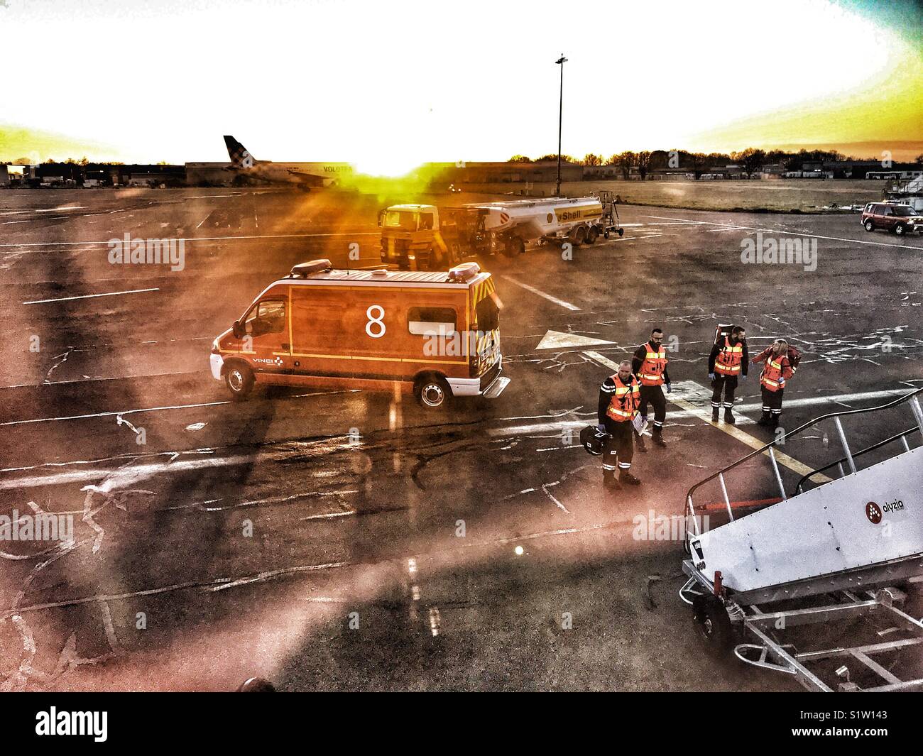 Emergency services waiting on the ground to meet an aeroplane which has landed in Nantes, France because of a passenger with a medical emergency on board the flight. - Smartphone Captured Stock Image