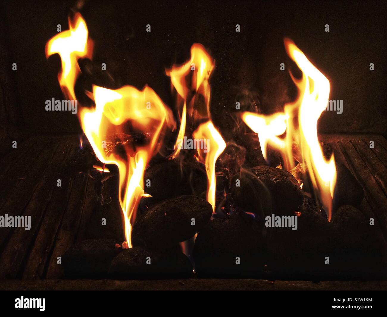 Dancing flames in an open fire place. Stock Photo