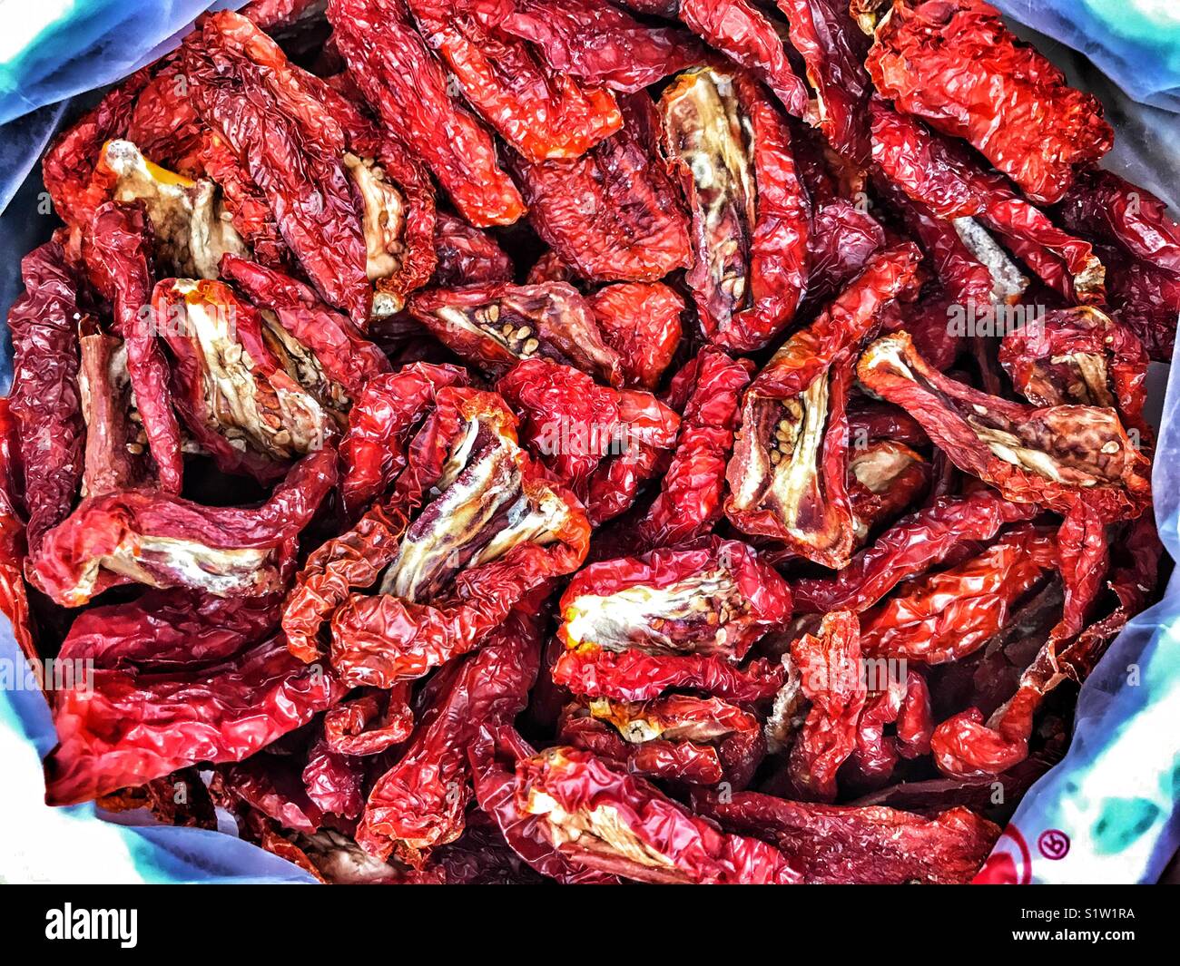 Sun dried tomatoes for sale on a market stall in Spain - Smartphone Captured Stock Image