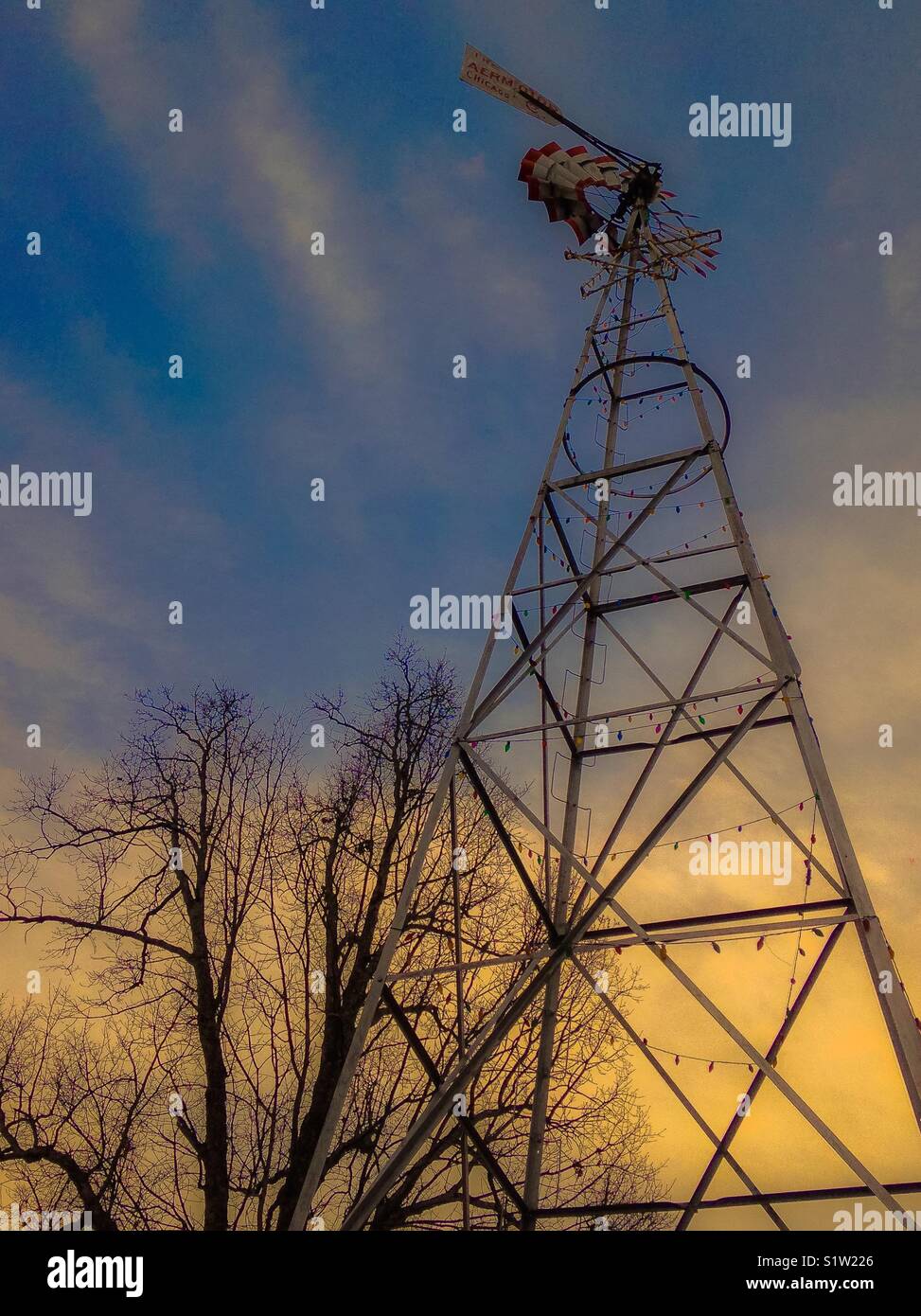 Christmas lights strung on farm windmill Stock Photo Alamy