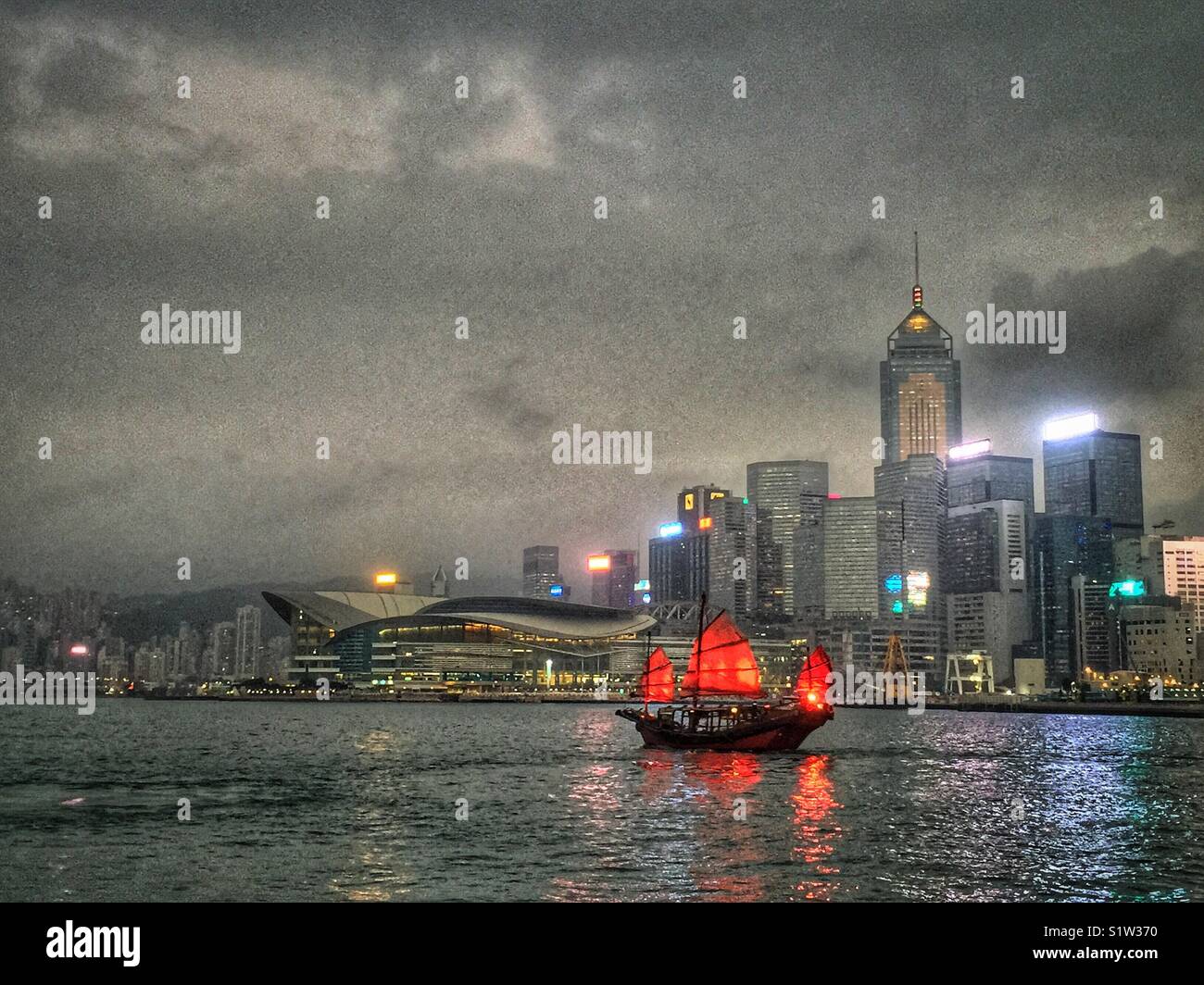 ‘Duk Ling’ a replica Chinese junk, transports tourists for sightseeing cruises on Victoria Harbour, Hong Kong - Smartphone Captured Stock Image