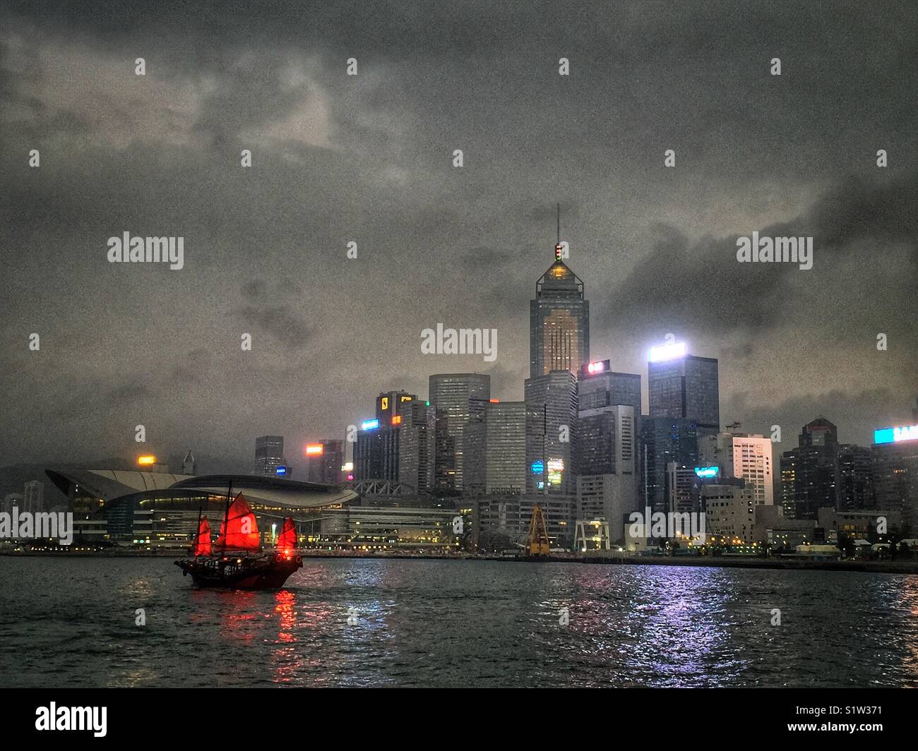 ‘Duk Ling’ a replica Chinese junk, transports tourists for sightseeing cruises on Victoria Harbour, Hong Kong - Smartphone Captured Stock Image