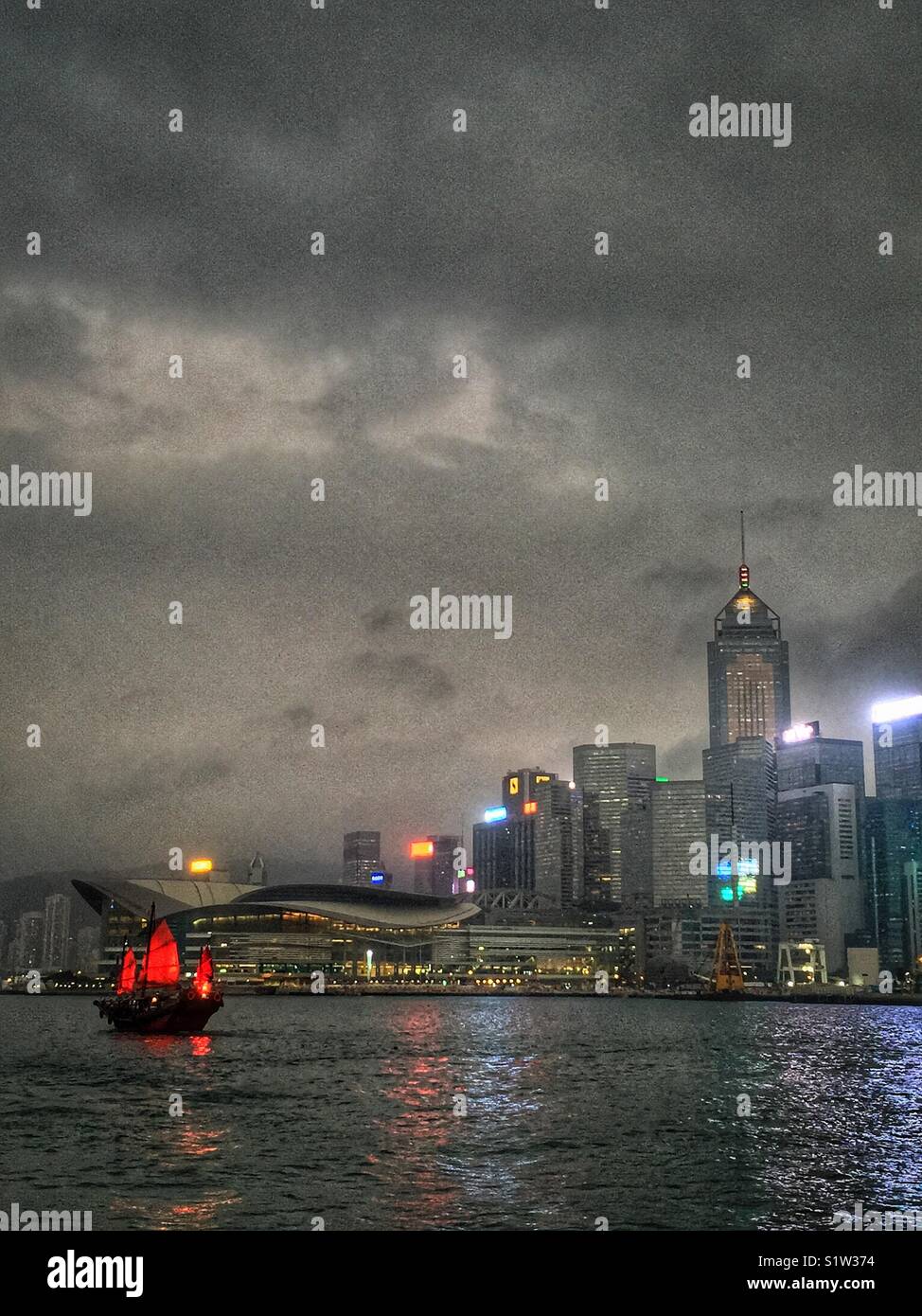 ‘Duk Ling’ a replica Chinese junk, transports tourists for sightseeing cruises on Victoria Harbour, Hong Kong - Smartphone Captured Stock Image