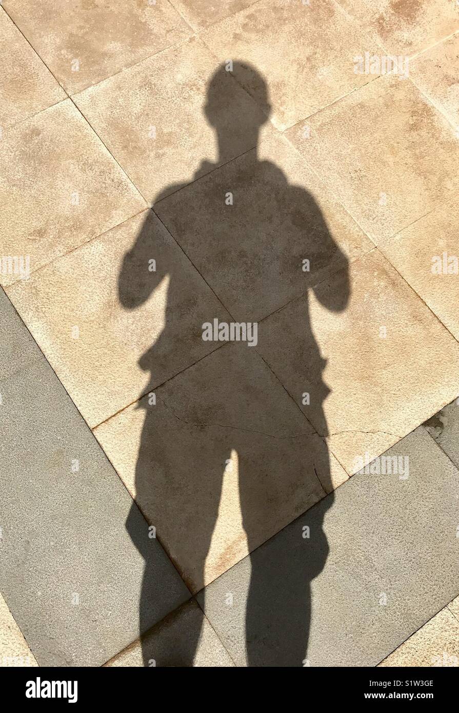 Shadows of man on sidewalk - Smartphone Captured Stock Image