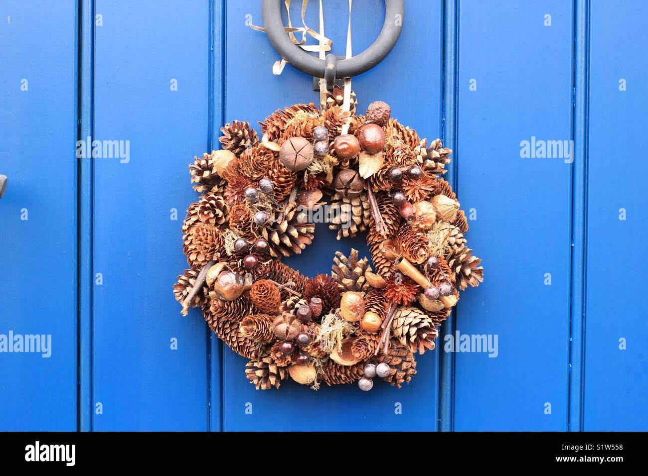 Christmas wreath tied to a house door Stock Photo