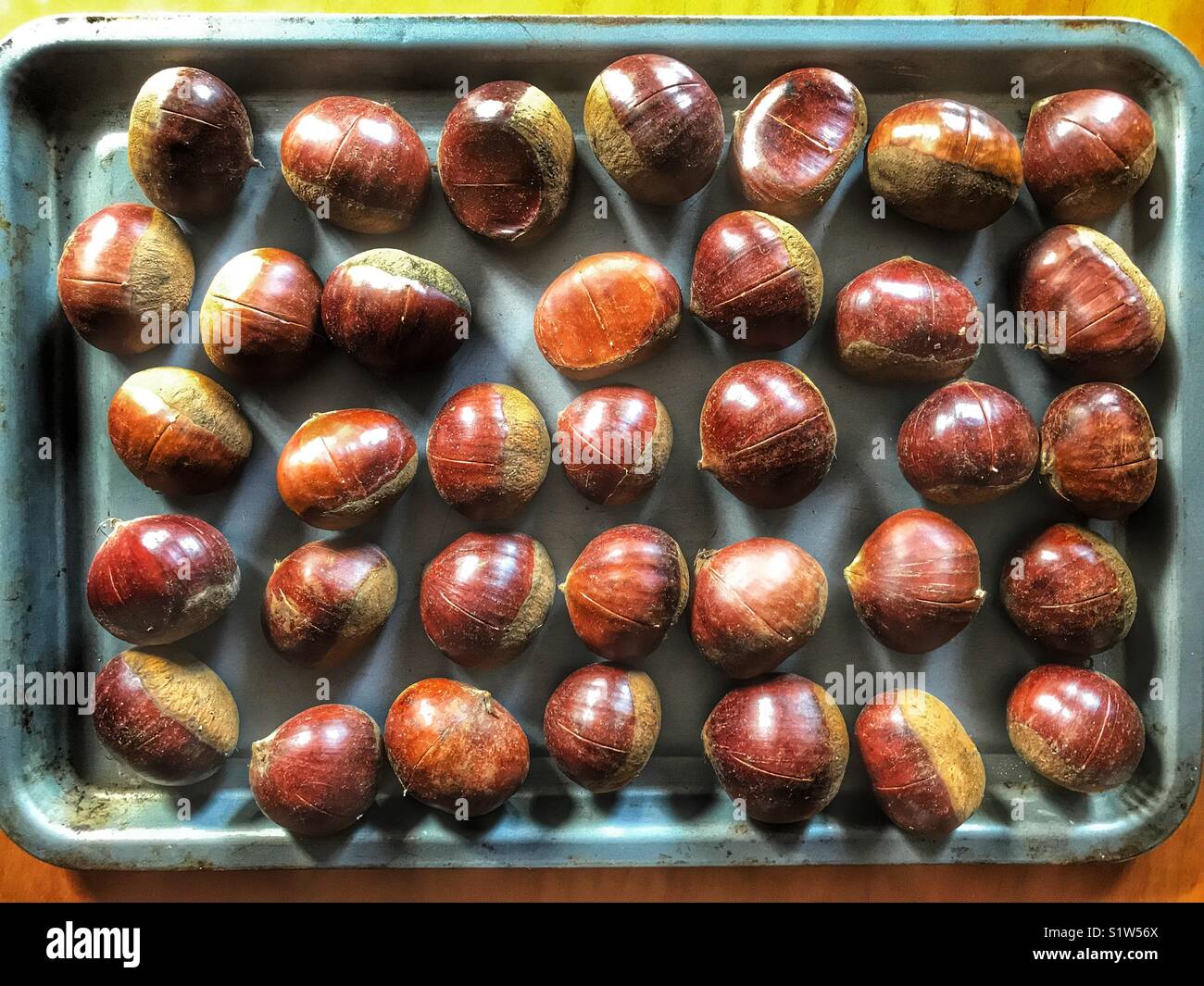 Chestnuts in a baking tray, ready to be toasted in the oven - Smartphone Captured Stock Image