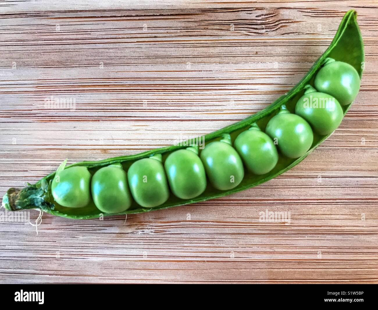 Fresh green peas in a pod. Stock Photo