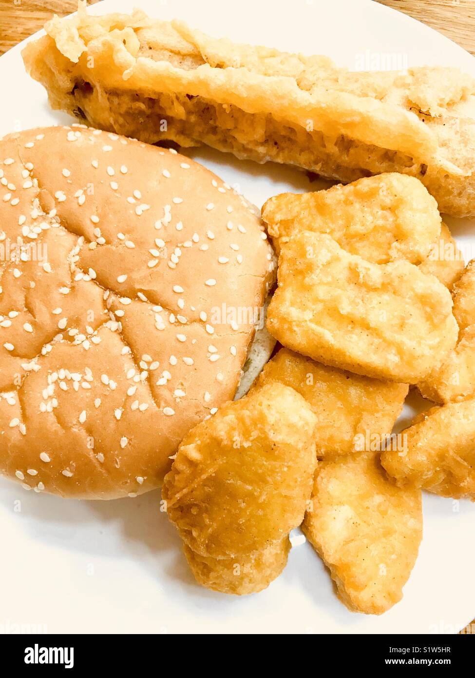 British chip shop food with chicken nuggets, battered sausage and a