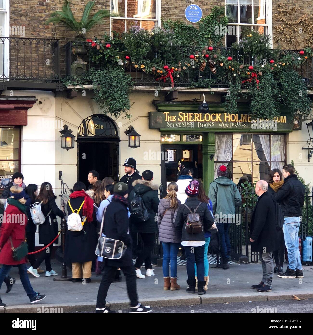 Crowds queuing up outside 221B Baker Street the home of the fictional private detective, Sherlock Holmes; made famous through the stories by Sir Arthur Conan Doyle. Stock Photo