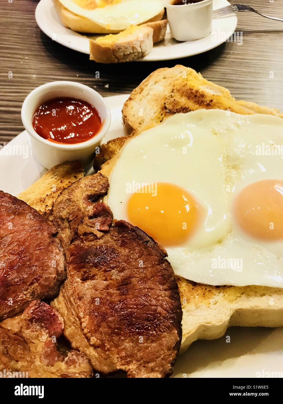 Bacon and fried eggs on white toast Stock Photo Alamy