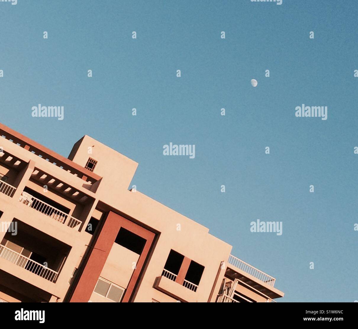 Moon in the morning above a building - Smartphone Captured Stock Image