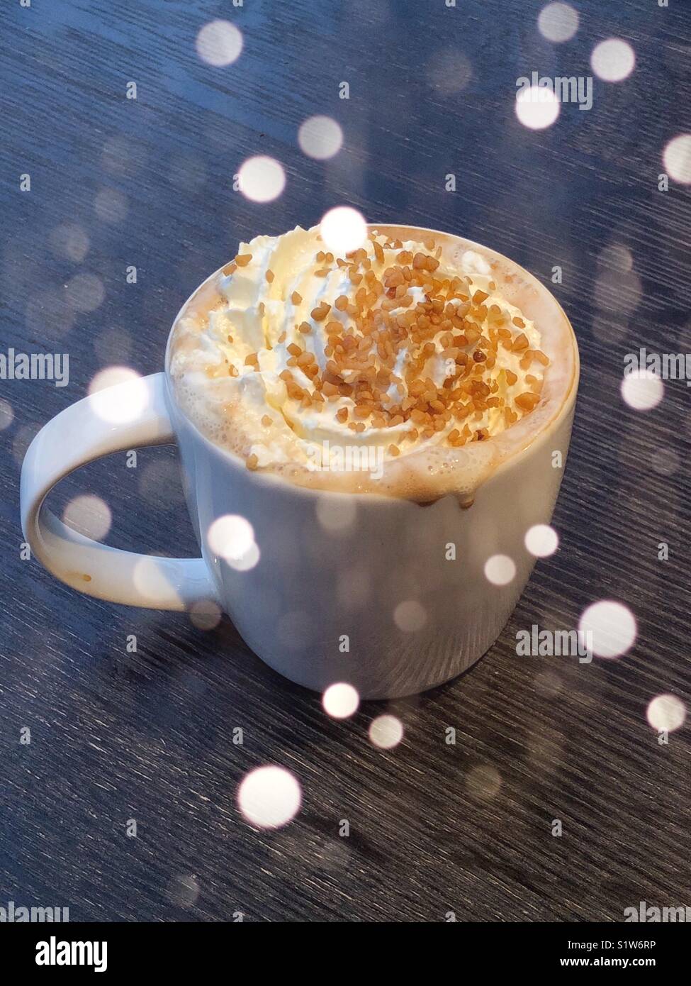 Toffee nut latte with nuts and cream in white mug with light bokeh flares  Stock Photo - Alamy