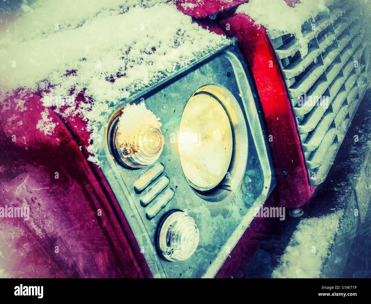 Front headlight and grill of Land Rover defender 4 wheel drive car in snow - Smartphone Captured Stock Image