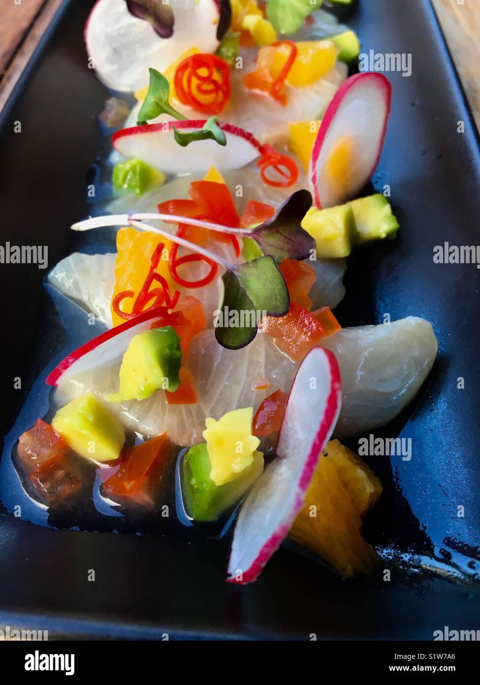 Cerviche with avocado, mango, radish and watercress Stock Photo