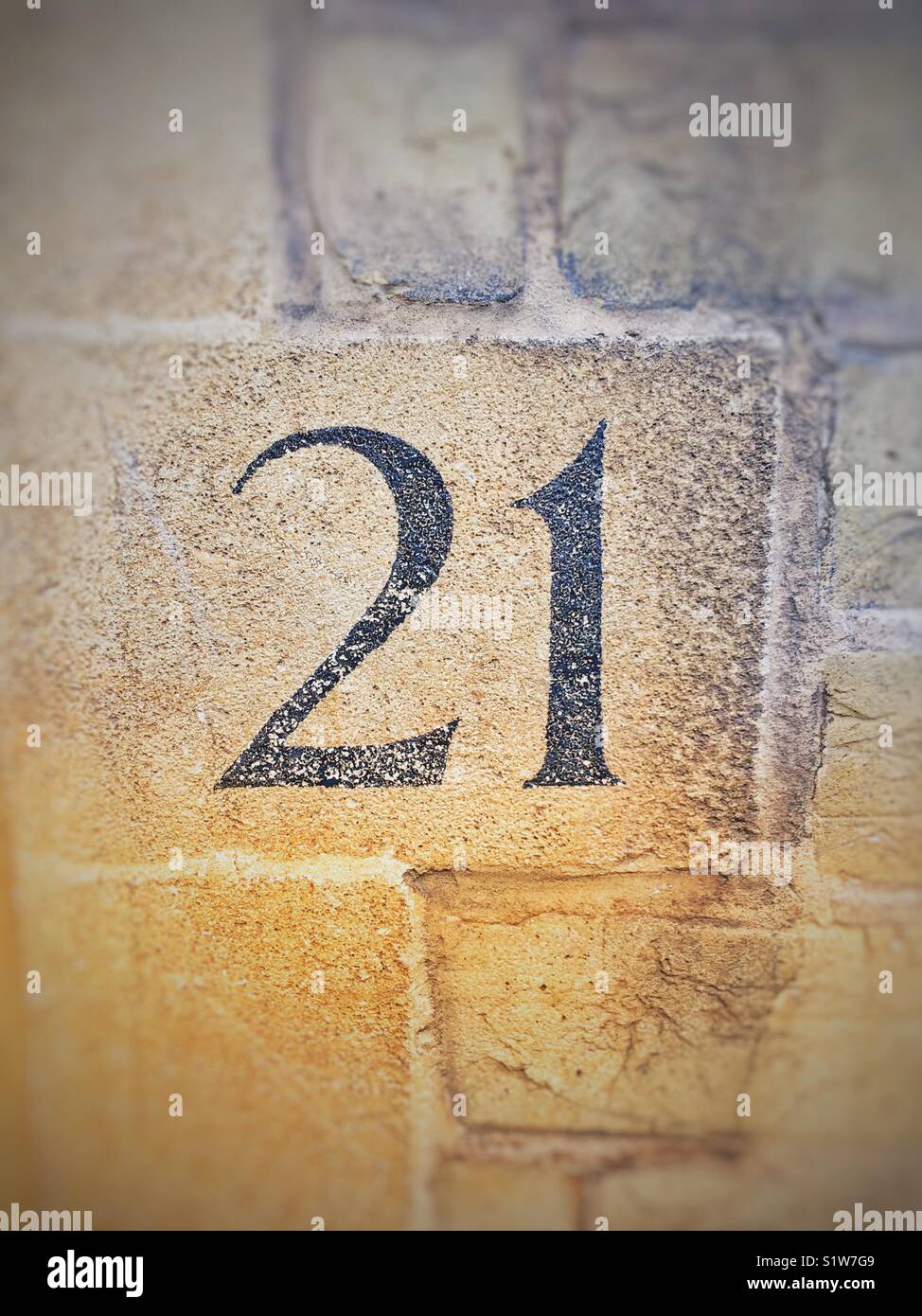 The number twenty one (21) on a brick wall. Stock Photo
