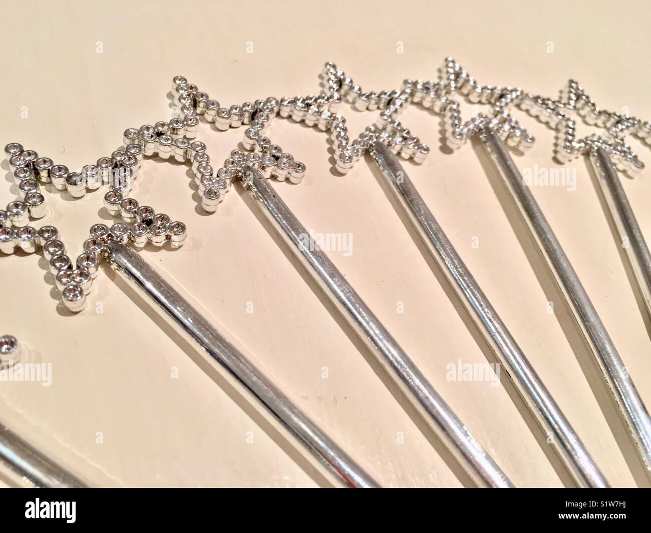 Fan of silver star wands on a white background Stock Photo