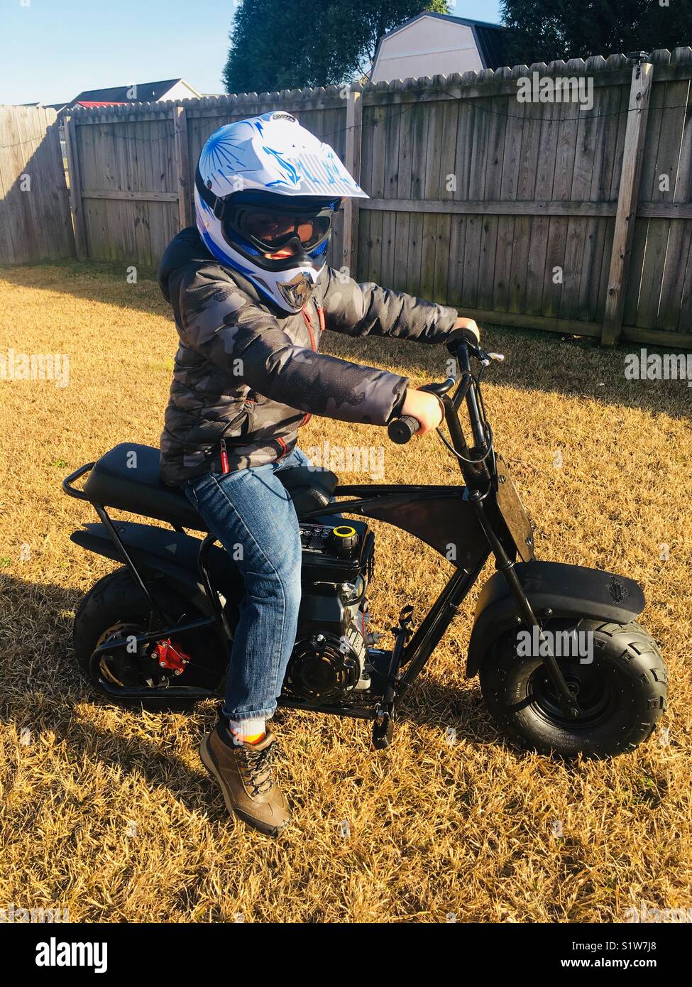 Boy on gas powered mini bike Stock Photo