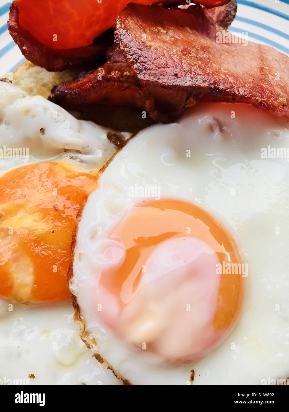 Breakfast, fried eggs and bacon on toast Stock Photo Alamy
