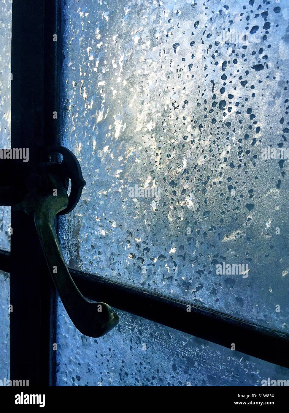 Ice encrusted frozen casement window pane, New York City, USA Stock ...