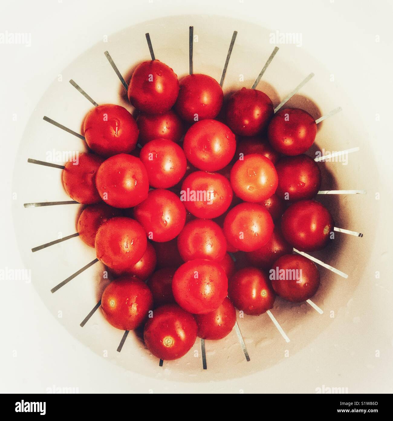 Cherry tomatoes, in a colander, high angle view - Smartphone Captured Stock Image