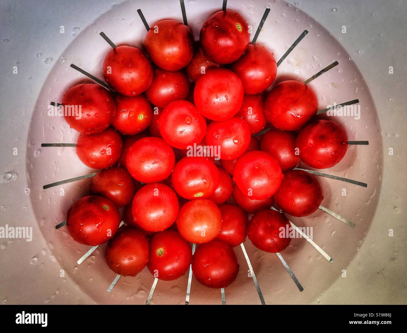 Cherry tomatoes, in a colander, high angle view - Smartphone Captured Stock Image