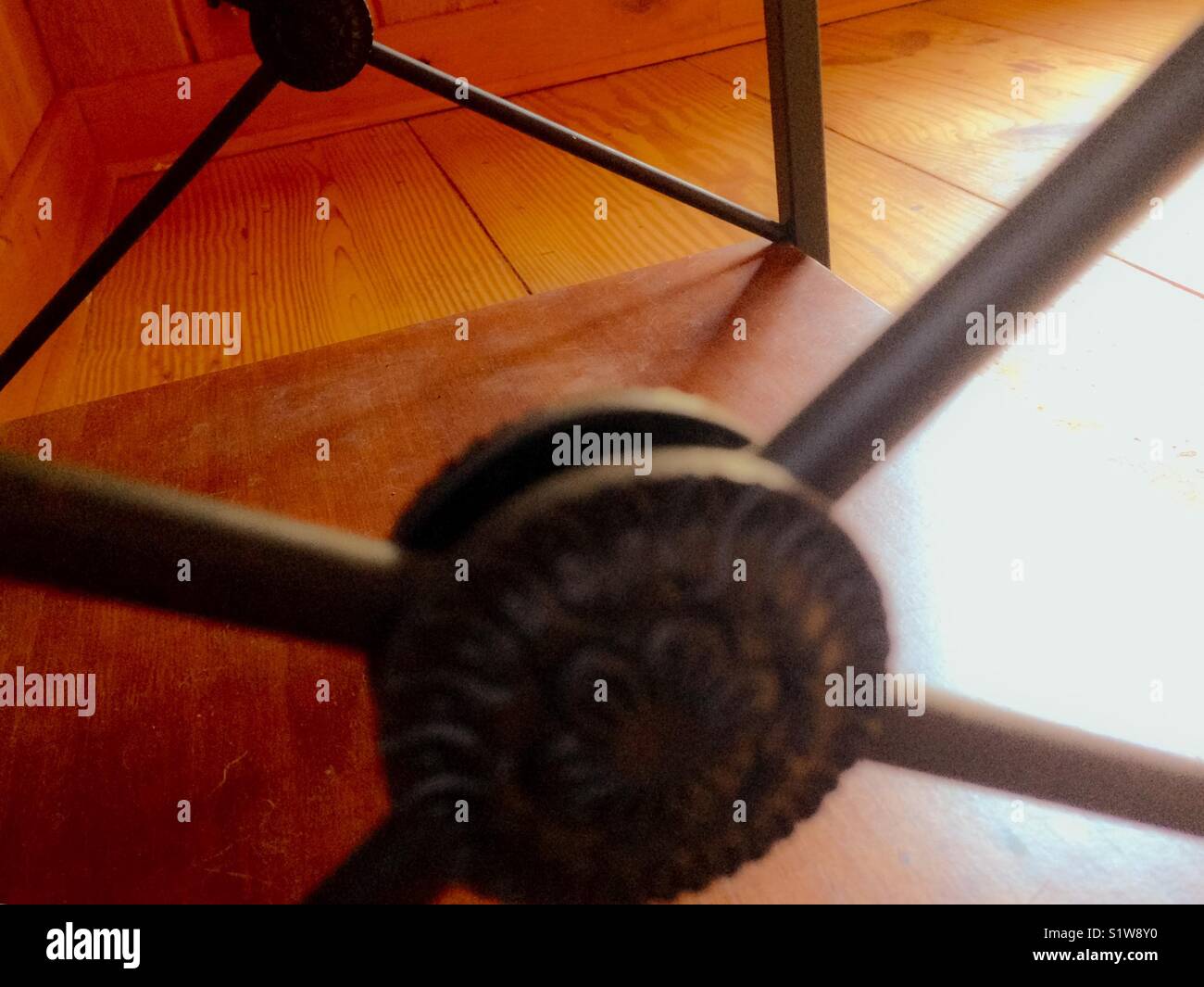 Bottom shelf of end table in window sunlight - Smartphone Captured Stock Image