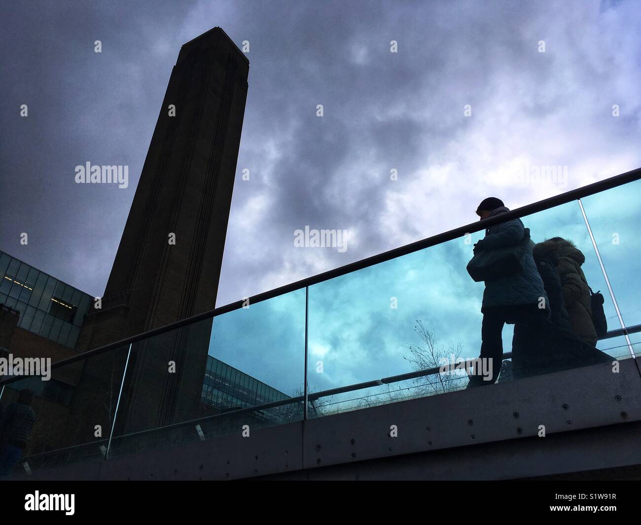 People walk across the Millennium Bridge by Tate Modern in London, England on January 1 2018 Stock Photo