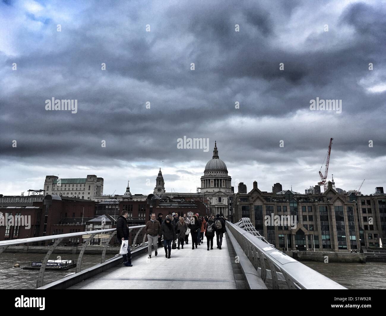 People walk across the Millennium bridge in London,  England on January 1 2018 - Smartphone Captured Stock Image