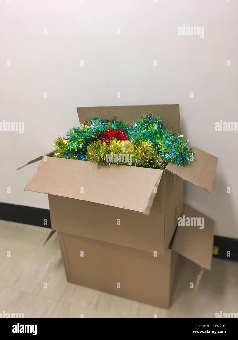 Christmas tinsel being packed away after Christmas. - Smartphone Captured Stock Image