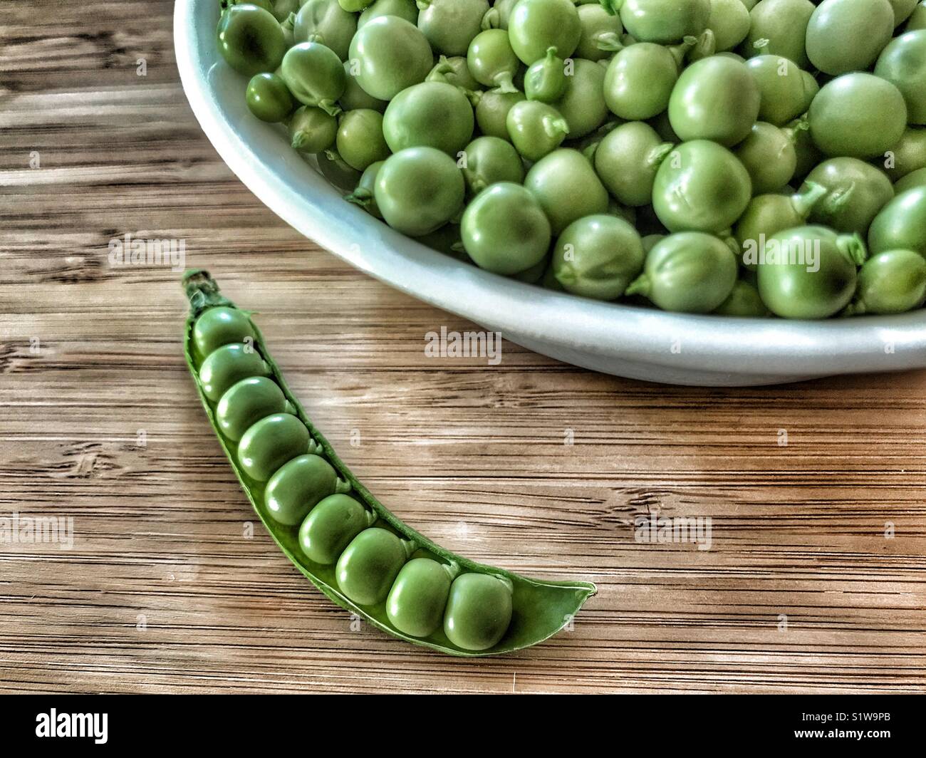 Peas in a bowl and peas in a pod - Smartphone Captured Stock Image