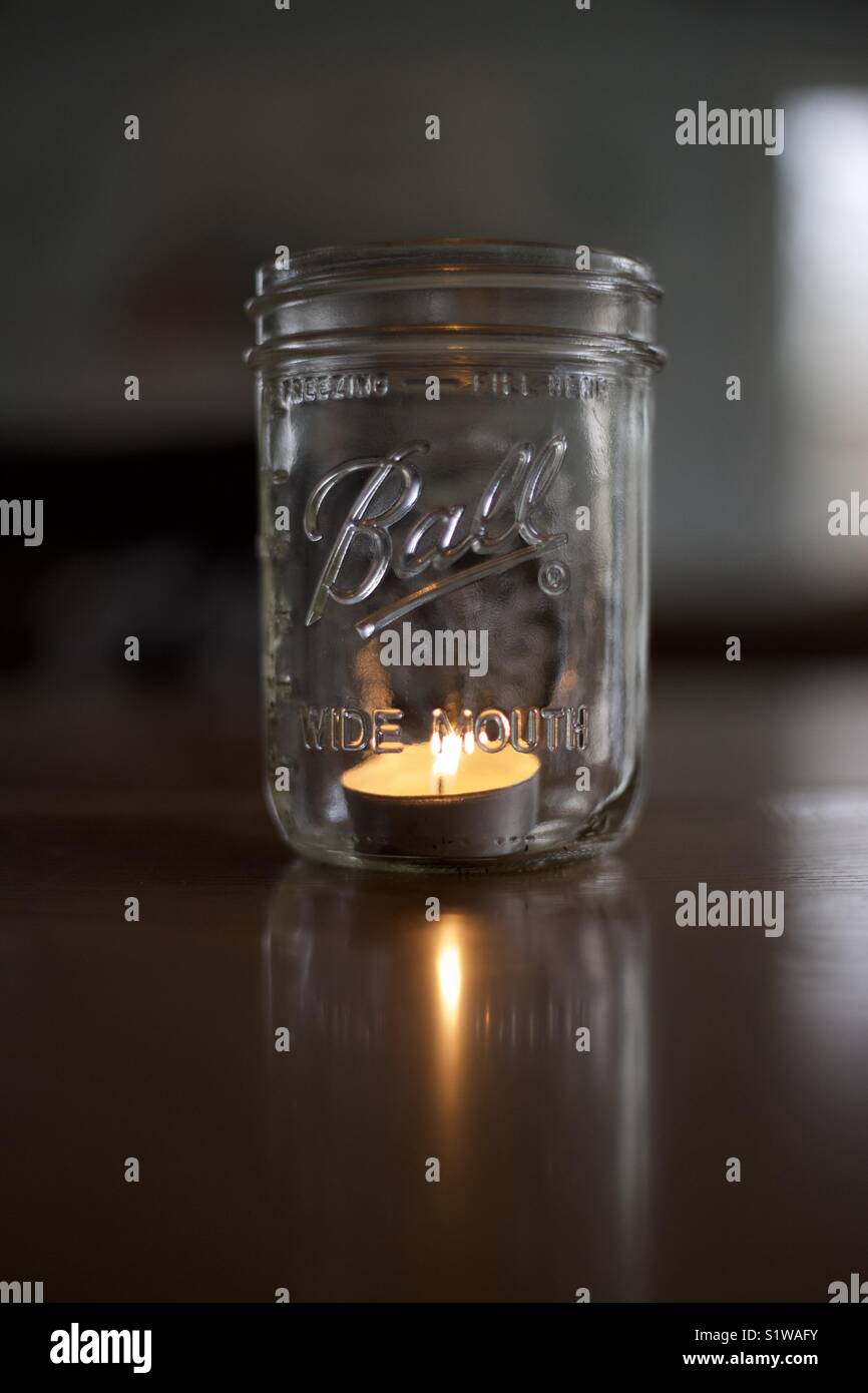 Candle burning in a mason jar Stock Photo Alamy