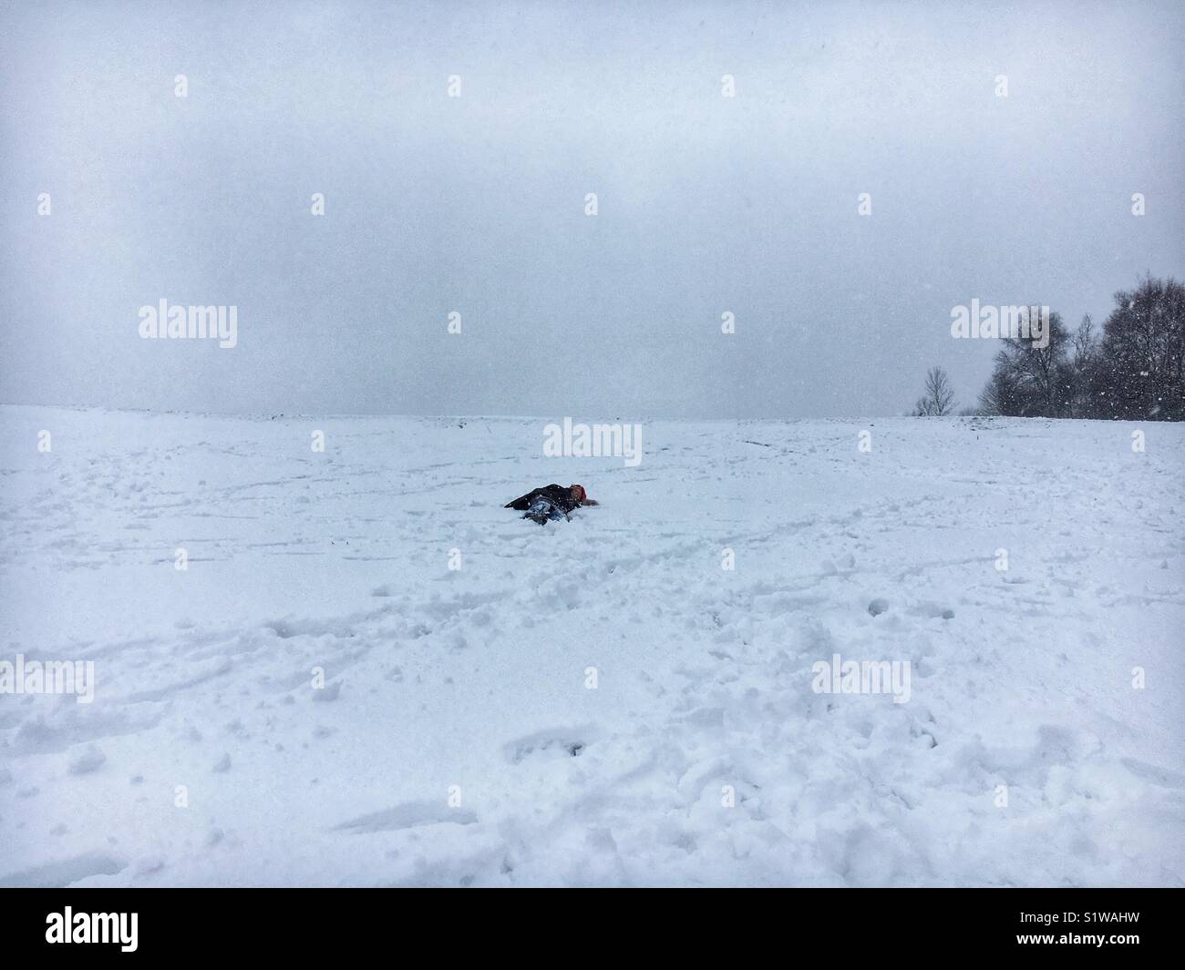 Woman collapsed in snow - Smartphone Captured Stock Image