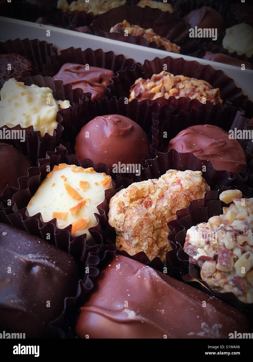 Mixed assortment of dark and light chocolates in a box. - Smartphone Captured Stock Image