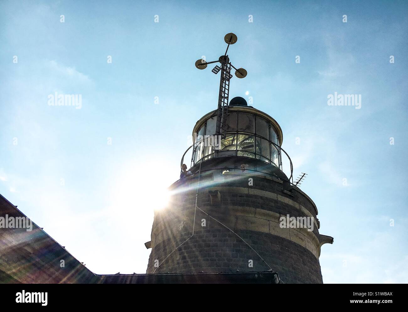 Lighthouse in the rays of light Stock Photo